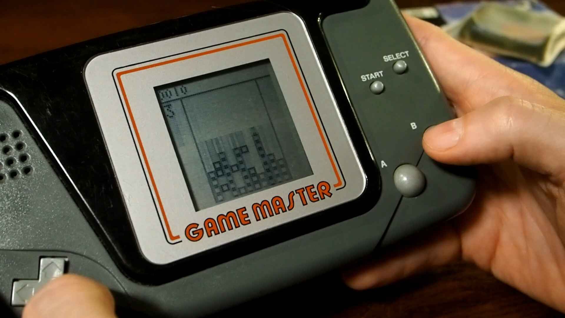 A Game Master handheld console demonstrating Falling Block; a Tetris clone