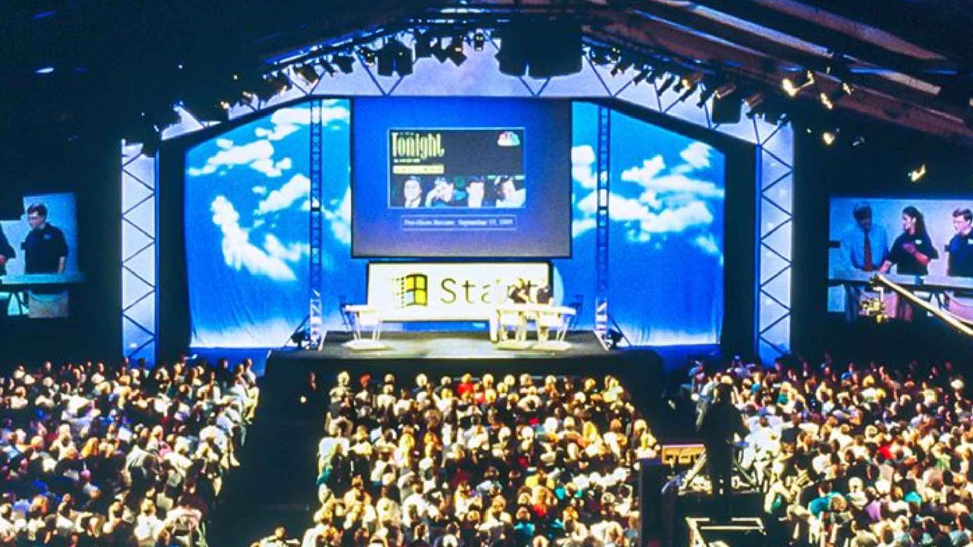 The Launch event stage, showing a big screen above a huge Start button. The arena is packed full of people.