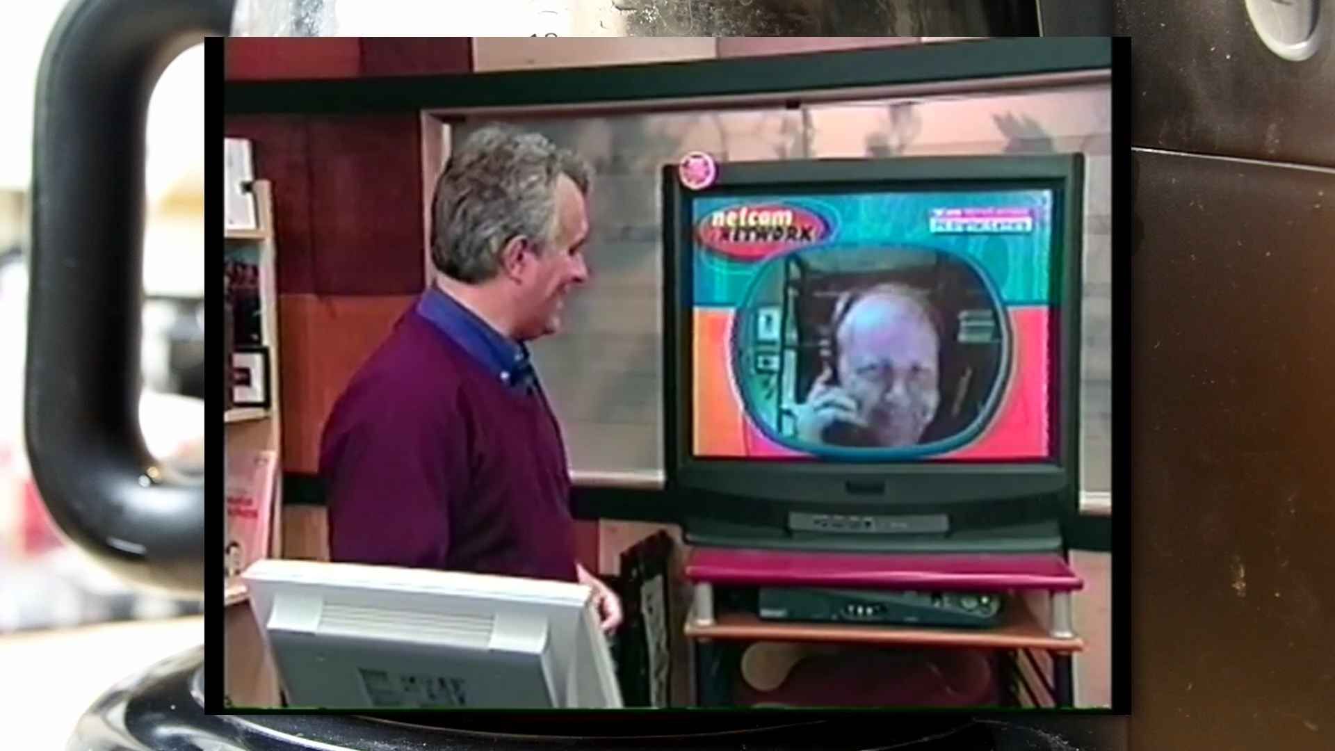 ZDTV Network running an interview with Quentin. Quentin has dialed up, and is shown on a CRT, holding a phone.