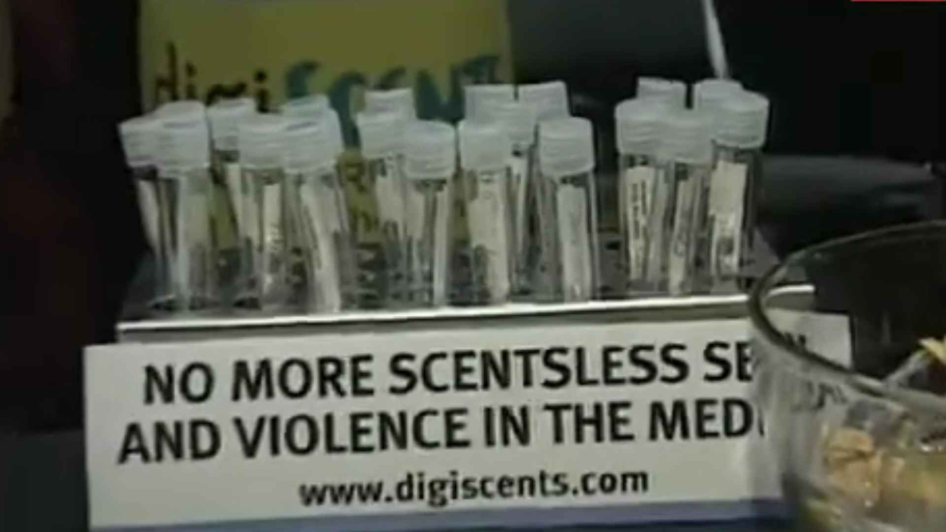 Test tubes filled with scents. The sign "No more scentsless sex and violence in the media" is displayed upon them